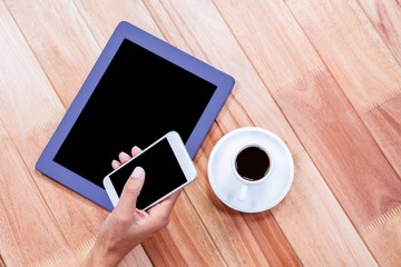 Businesswoman using her smartphone on desk