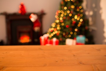 Fototapeta na wymiar Desk with christmas tree in background