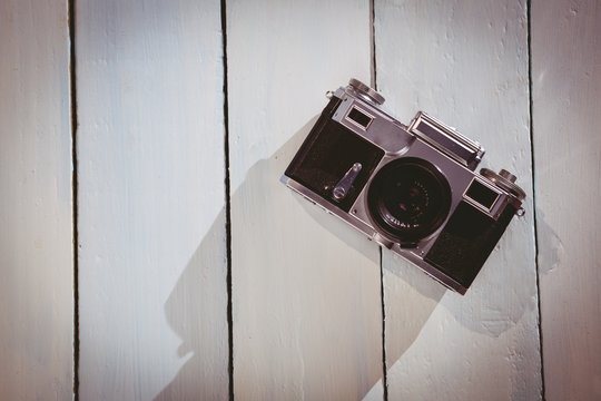 Old school camera on wooden floor