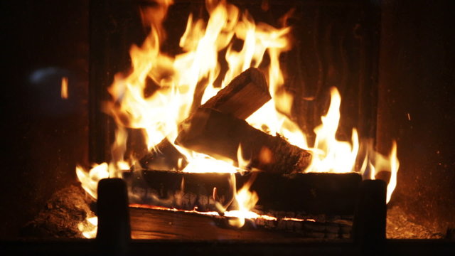 close up of firewood burning in fireplace