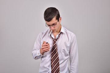 stressed young businessman lighting cigarette in studio