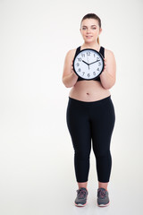 Smiling fat woman holding wall clock
