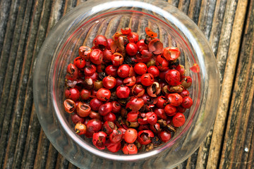 Red peppercorn on wooden background