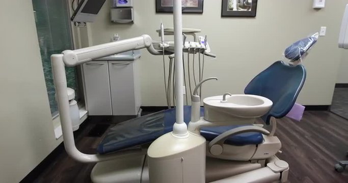 Empty Dentist Chair in Dental Room. camera moves right then left on an empty dentist chair in a dental room. modern style room and layout.
