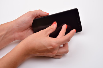 Closeup shot of a woman typing on mobile phone isolated on white