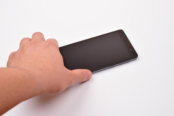 Male hand taking blank mobile smartphone with clipping path for