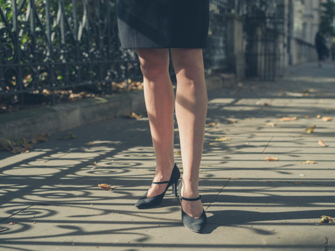 Legs of young businesswoman in the park