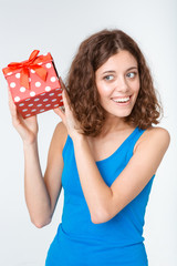 Smiling young woman holding gift box