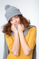 Happy thoughtful woman with scarf and hat