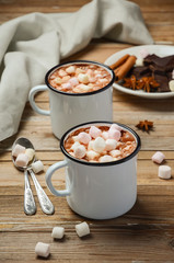 Hot chocolate with marshmallows on the rustic wooden table