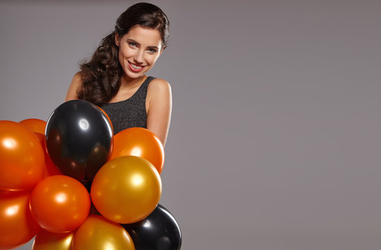 Smiling Woman Holding Ballons And Celebrating