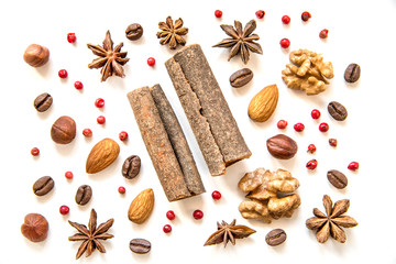 Fototapeta na wymiar nuts and spices on white background, сinnamom, Illicium, almond, coffee beans, pink peppercorn