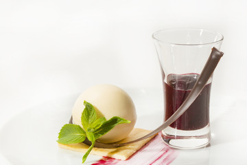 creamy dessert is decorated with blackberries on a white background