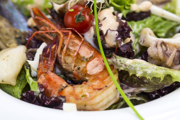 salad with vegetables and seafood on the table in a restaurant