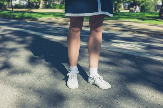 Legs of young woman in park