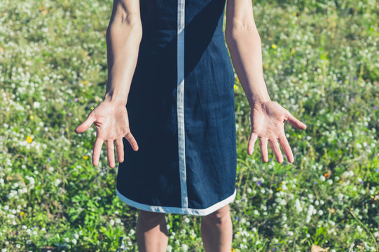 Woman showing her hands in a meadow