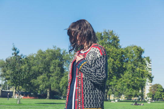 Woman wearing knitted jumper in the park