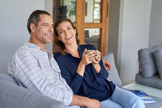 husband and wife interacting sitting on patio garden couch