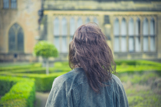 Young woman exploring formal garden