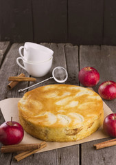 Apple biscuit pie on a dark wooden background