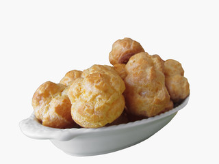 Delicious beignets composed of a shell of choux pastry isolated on white background