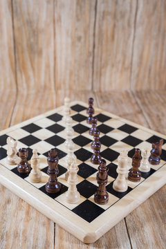 a chessboard and black and white figures
