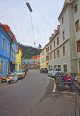 Street view of parking and the Clock tower of the Castle Hill 