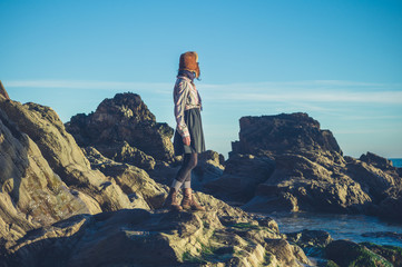 Woman in hat standing on rocks