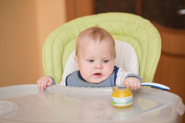 baby eating in high chair