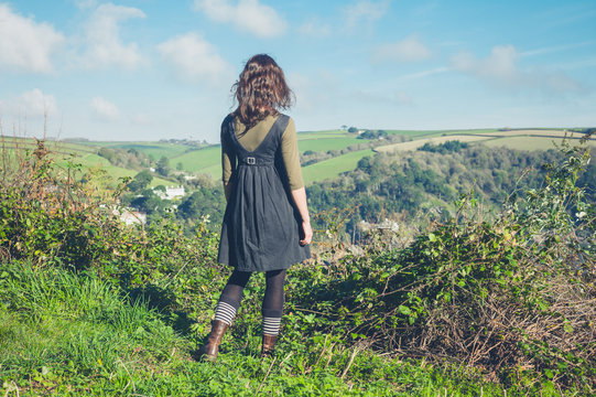 Woman admiring countryside from hill