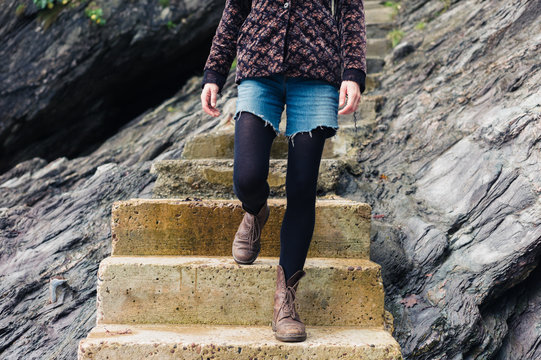 Young woman standing on steps in nature