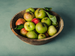 Bowl of apples on green table