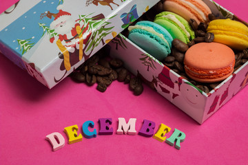 Fototapeta na wymiar Tag december, colorful macaroons in the gift box