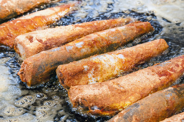 In a large pan some fried in bread crumbs fishes