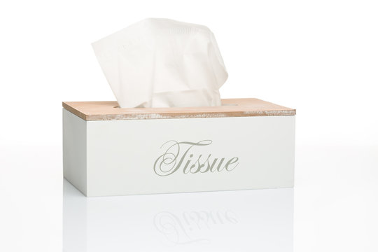 Wooden box of tissues on a White table