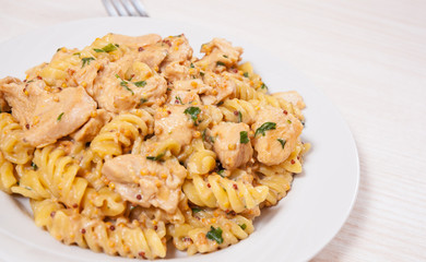 Sliced fried chicken fillet in a creamy and mustard sauce. with fusilli pasta