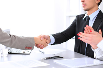 Business people shaking hands, finishing up a meeting. Copy space  at the left corner