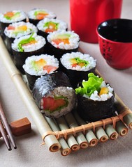 Vegetarian homemade sushi with avocado, tomato, peppers and lettuce.