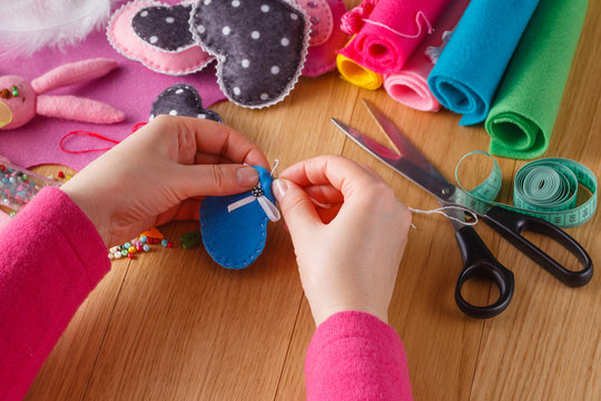 Female hands doing crafts from felt