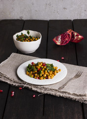 Salad from the baked chickpea, pomegranate, parsley in white pla