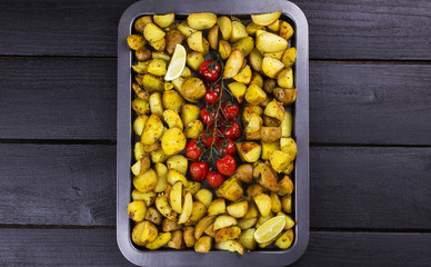 Fried potato and the baked cherry tomatoes on branch, segments a