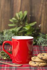 Red cup of coffee, vanilla cookies with chocolate chips