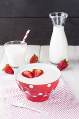 semolina strawberry in red bowl on fabric napkin on a white tabl