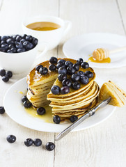 heap of pancakes the slices of pancakes watered with honey and b