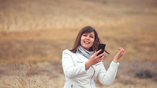 woman girl smartphone makes self phone sitting on dry tree autumn nature