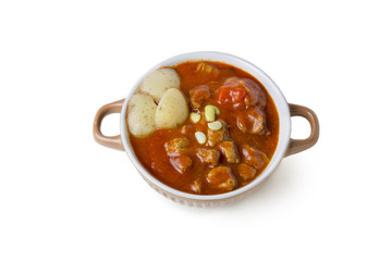Beef stew in bowl with tomato sauce , isolated  background