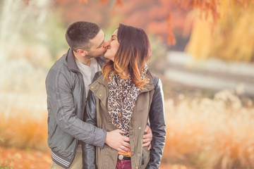 Young couple kissing in a park