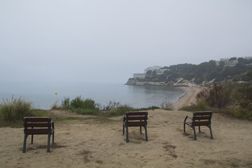 Three empty chairs in the coast