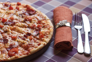 Pizza with bacon and tomatoes