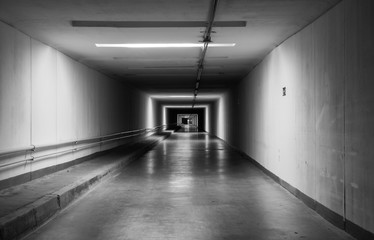 Empty dark tunnel at night. Monochrome